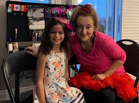Melissa, owner of Fantasy Face Painting in Ottawa, Ontario, painting a child at a birthday party
