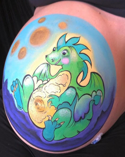 A close up view of a friendly dragon prenatal belly painting design in Ottawa.